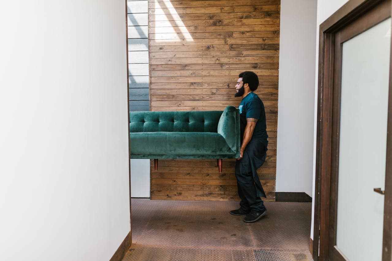 Jones mover carefully lifting a couch during a move