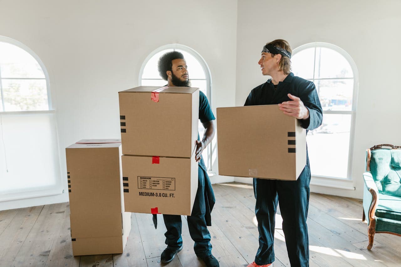 Two Jones movers carrying a moving box together