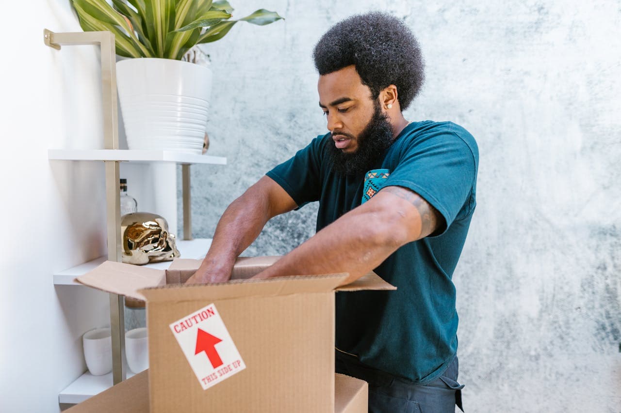Jones team member loading a moving box into the van